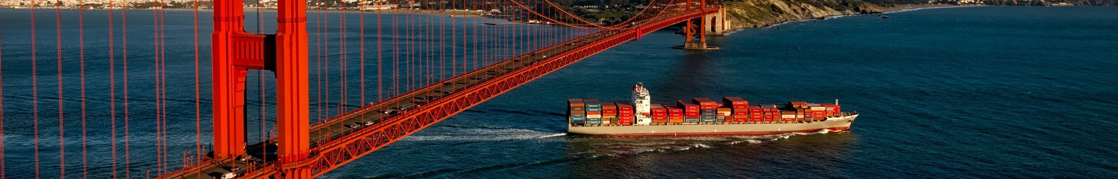 Container ship passing under Golden Gate Bridge
