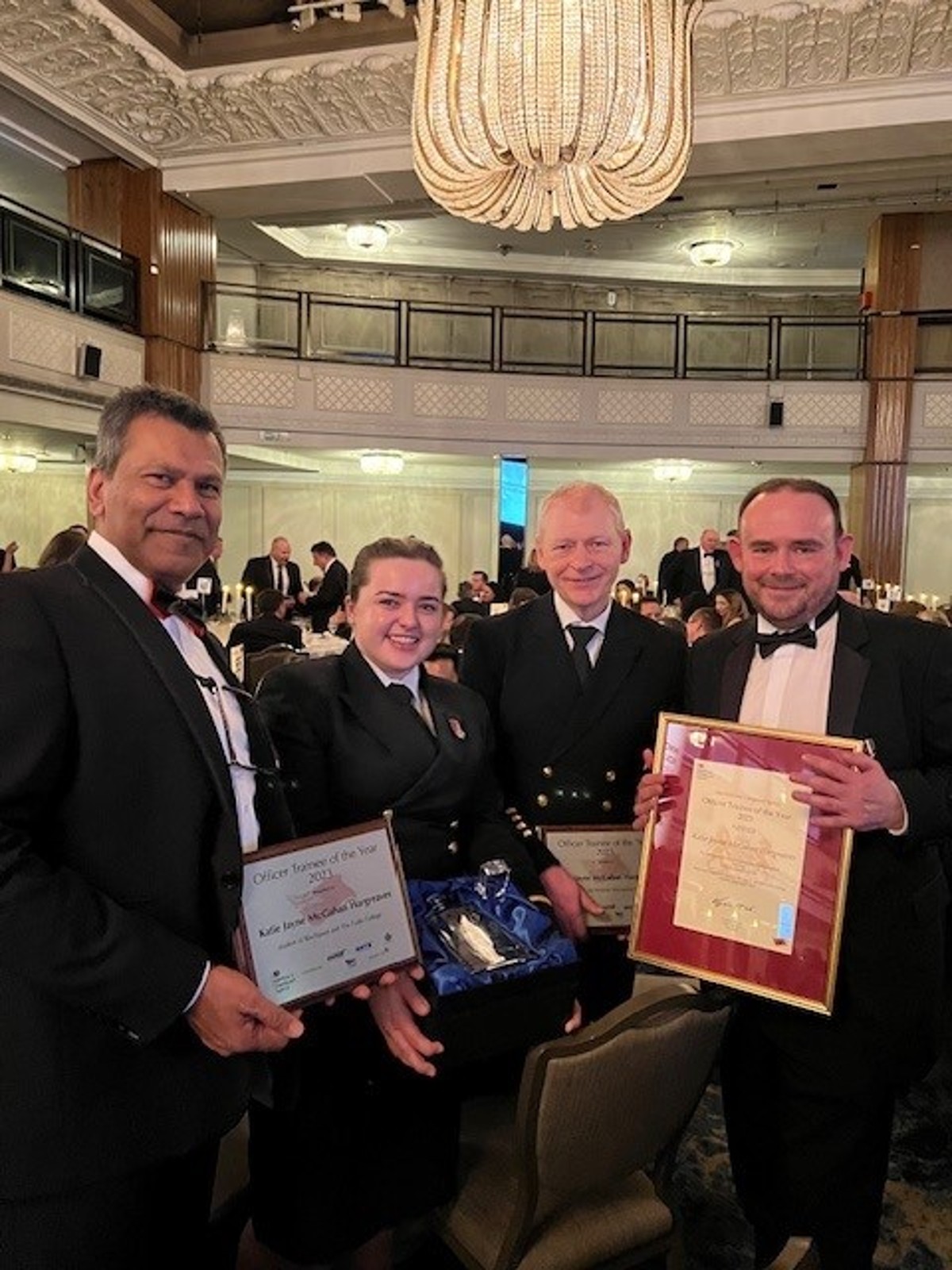 Katie receiving award with Shajan and Neil